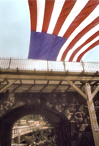 Railroad bridge with flag and view of Oella. Ellicott City.