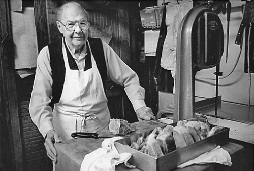 Balden Yates, butcher, at meat counter of Yates' Market, Ellicott City