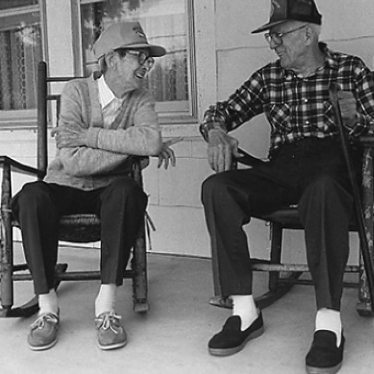 Ed Fisher and George Tucker "jawing" on the porch, Oella