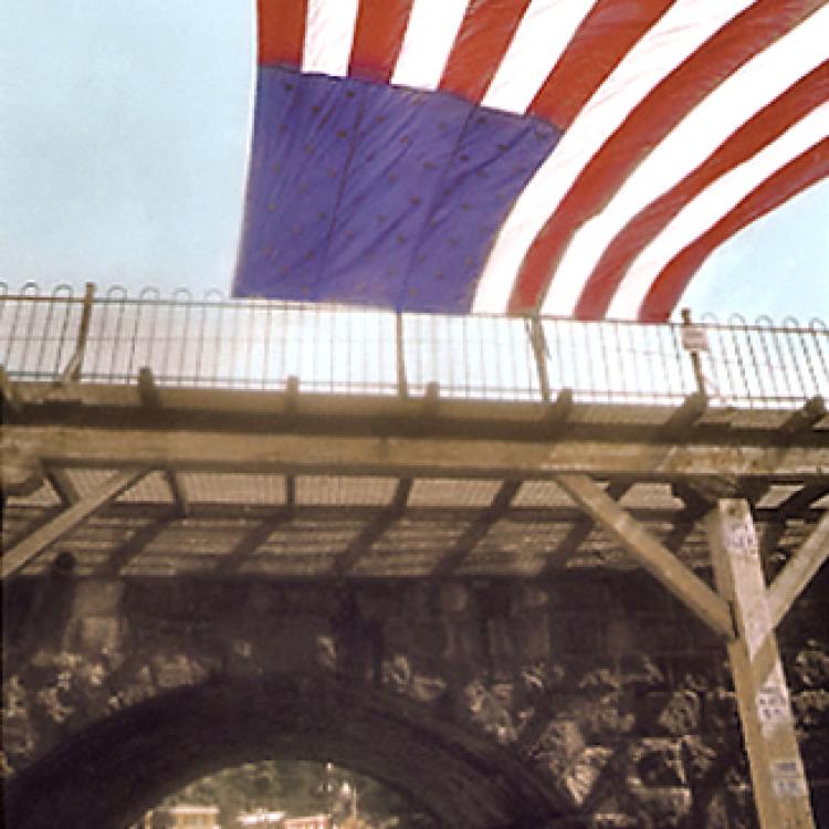 Railroad bridge with flag and view of Oella. Ellicott City.