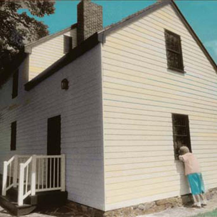 Elaine May peeks thru the window of her family home, now part of Patapsco state park