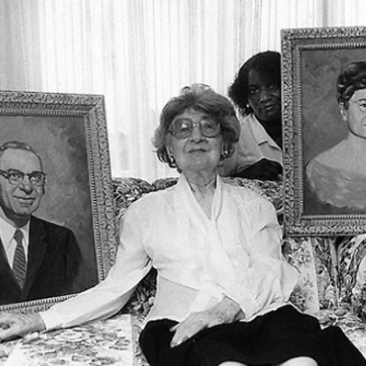 Gertrude Caplan, owner of Caplans furniture store, with portraits of herself and husband Sam, and nursing aide, Ellicott City