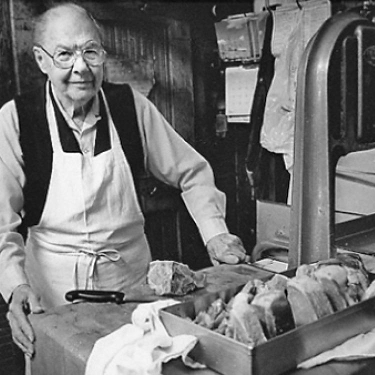 Balden Yates, butcher, at meat counter of Yates' Market, Ellicott City