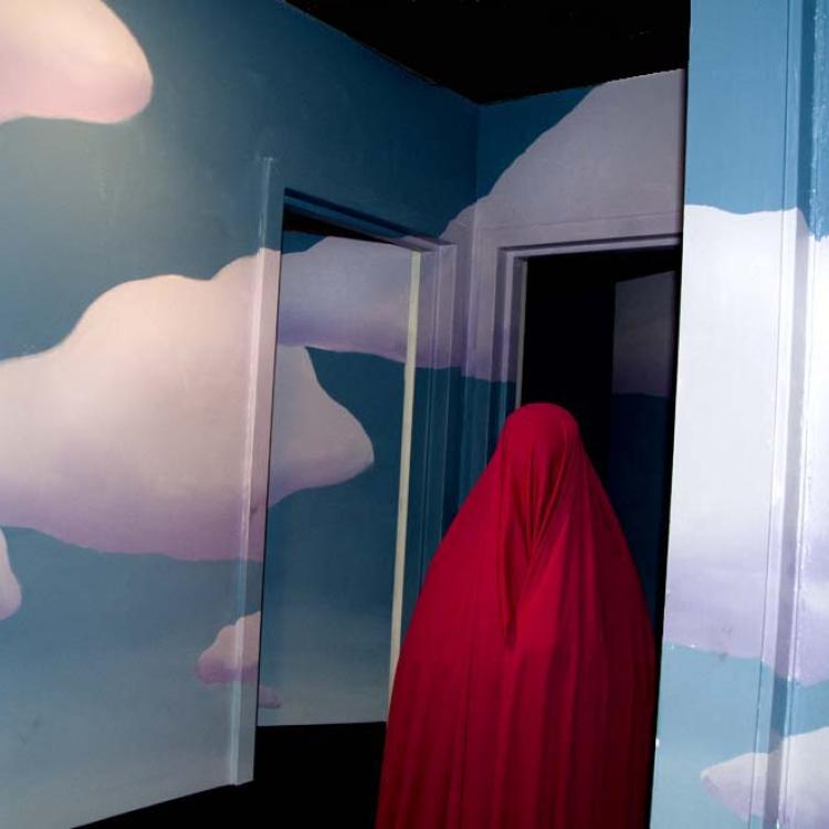 Wrapped figure with cloud mural.